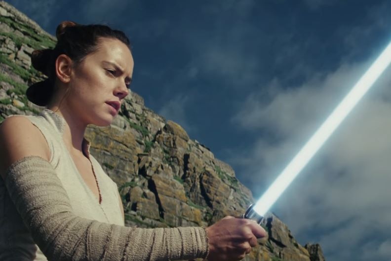 Rey with a lightsaber in the trailer for Star Wars: The Last Jedi