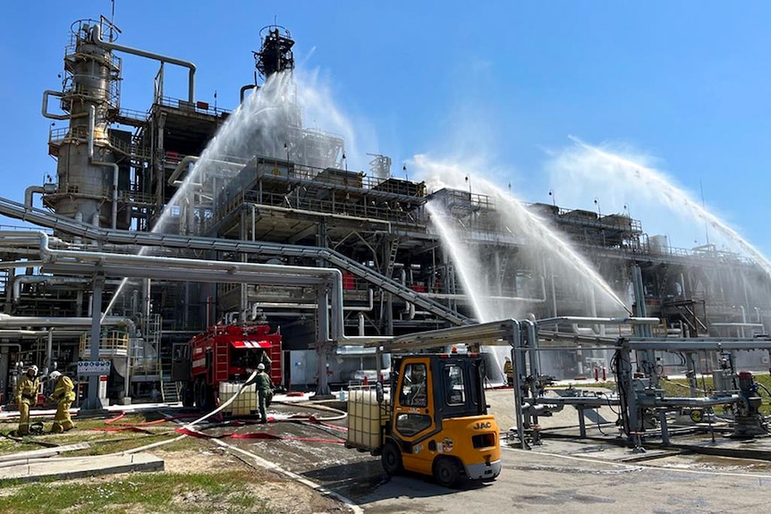 Firefighters putting out a fire at an oil refinery plant.