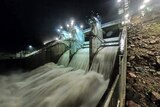 Water flows over spillway of Ross River Dam between Kelso and Mount Stuart in Townsville.