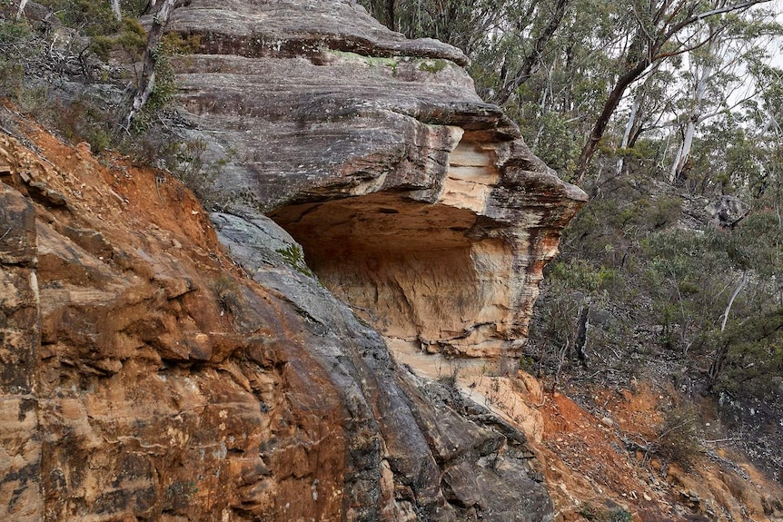 A sandstone rock has been cut to reveal a path
