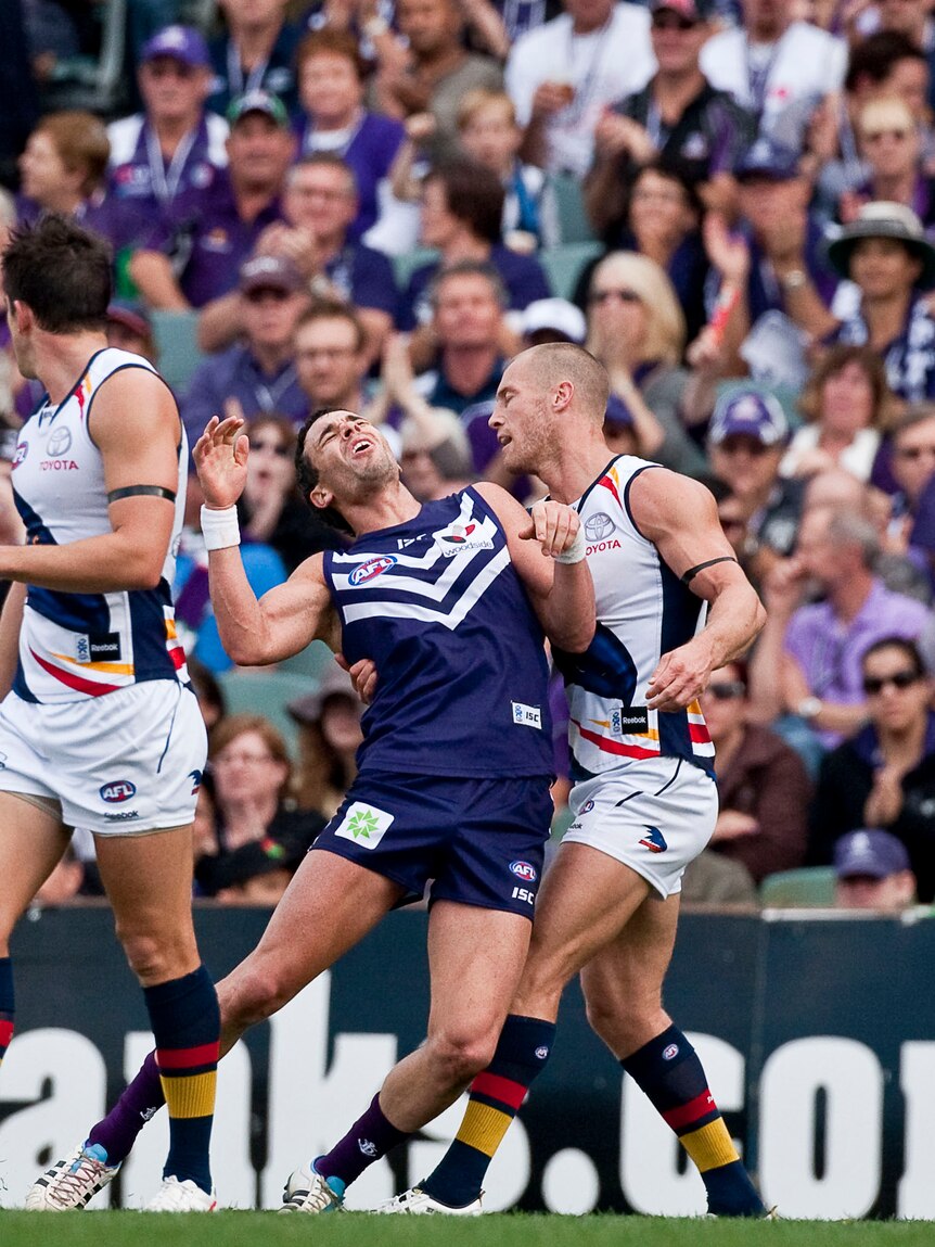 Caught on camera ... Ryan Crowley threw his head back after some minor contact from the Crows.
