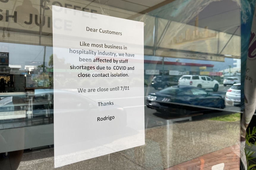 A sign in the window of a cafe explaining the business had to close.