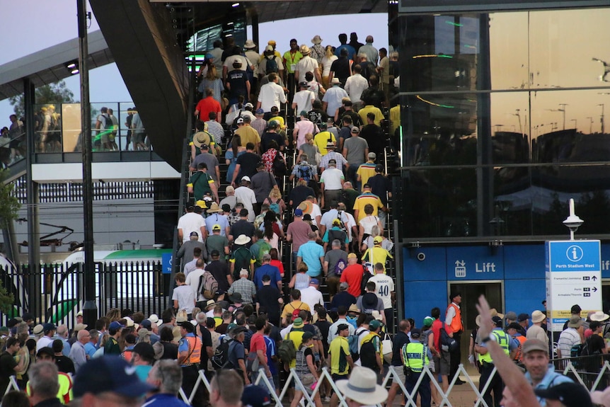 Fans are seen packing a staircase at a train station