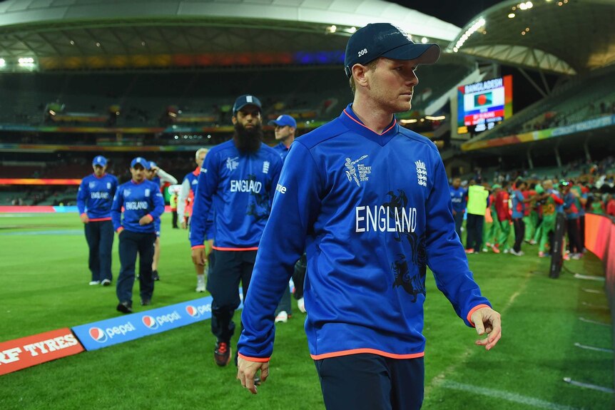 Eoin Morgan leads his team off the ground after losing to Bangladesh