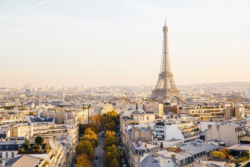 Crowed city at sunset - Eiffel tower features prominently