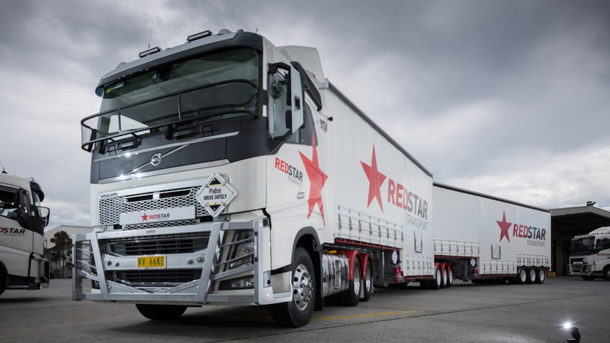 The front of a Redstar Transport truck with Redstar written on the side