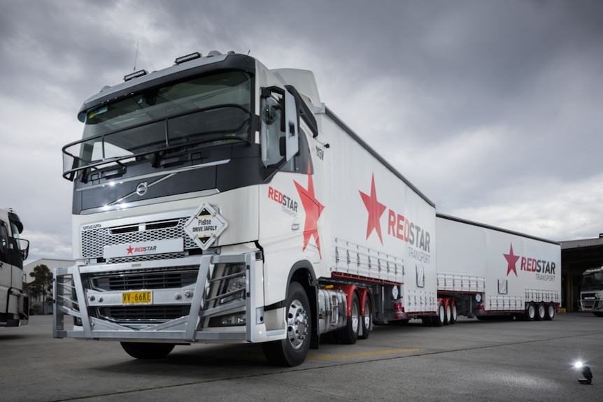 The front of a Redstar Transport truck with Redstar written on the side