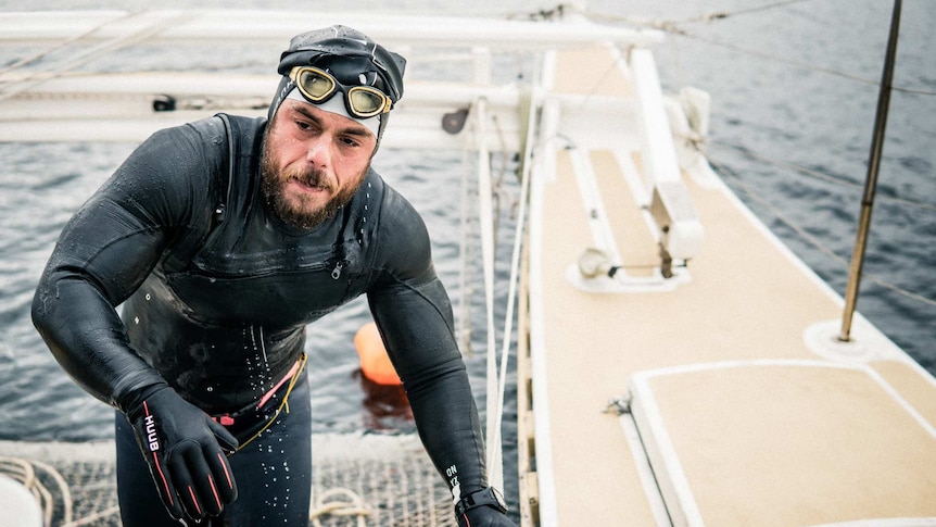 Extreme endurance swimmer Ross Edgley climbs aboard his boat after another six hours swimming in the English Channel.