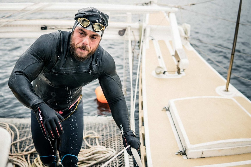 Extreme endurance swimmer Ross Edgley climbs aboard his boat after another six hours swimming in the English Channel.