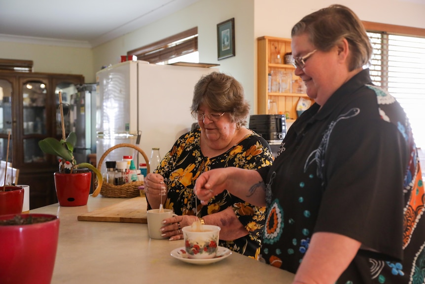 Lisa Dodson and her mother make cups of tea in the kitchen.