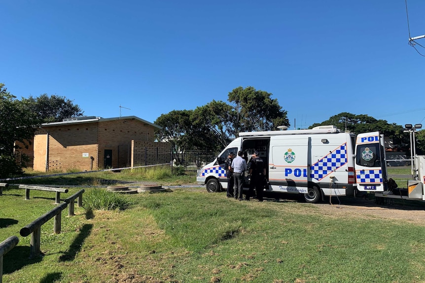 Police at the scene in Wynnum, with a major incident van and police tape around the sewage tank.