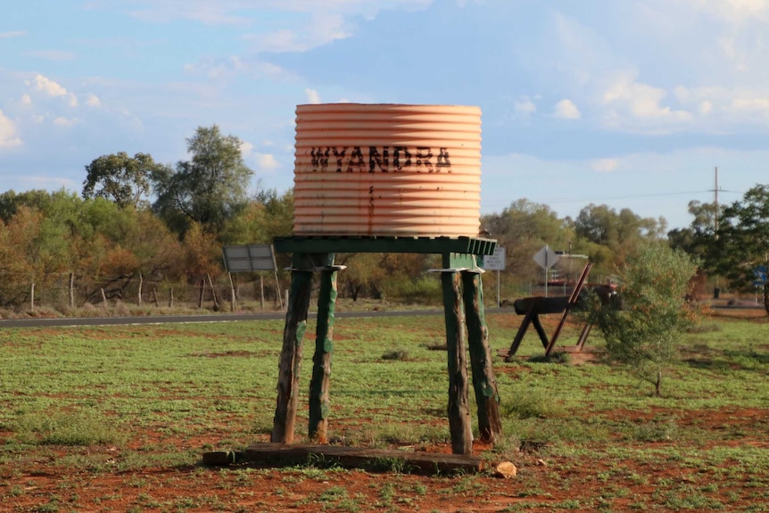A water tank on stilts reads Wyandra