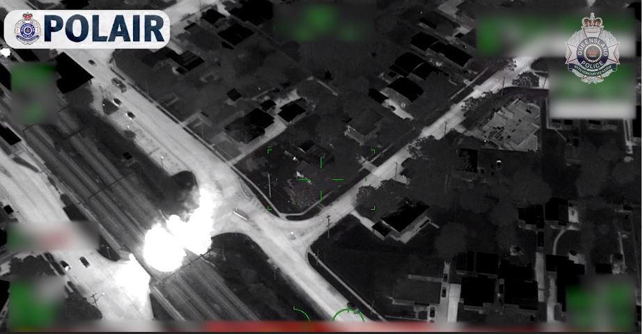 A fire glowing in black and white police video