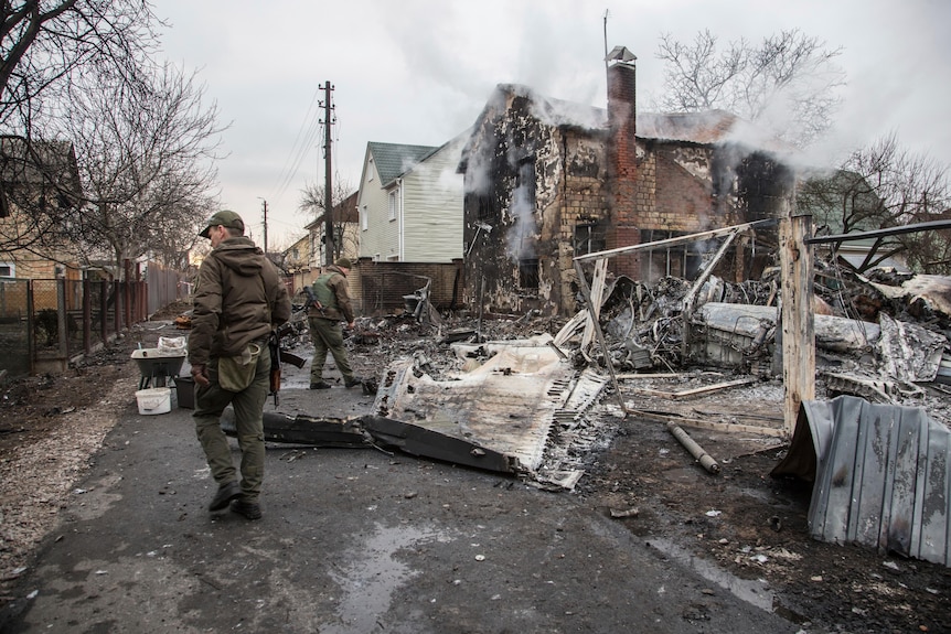 Ukrainian servicemen walk at fragments of a downed aircraft seen in in Kyiv,.