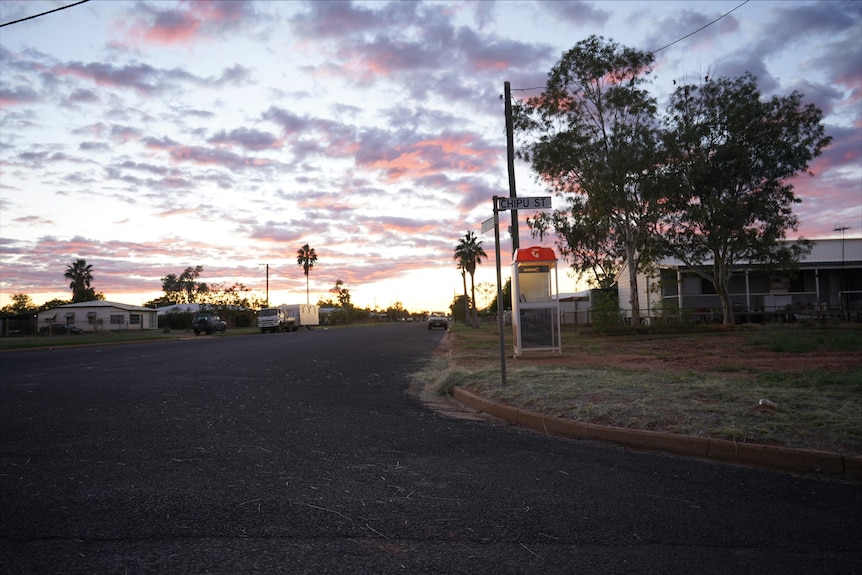 Town street with telstra phone box at sunset