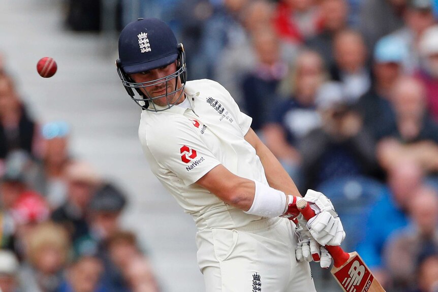 Rory Burns leans to one side as the ball flies past his head.