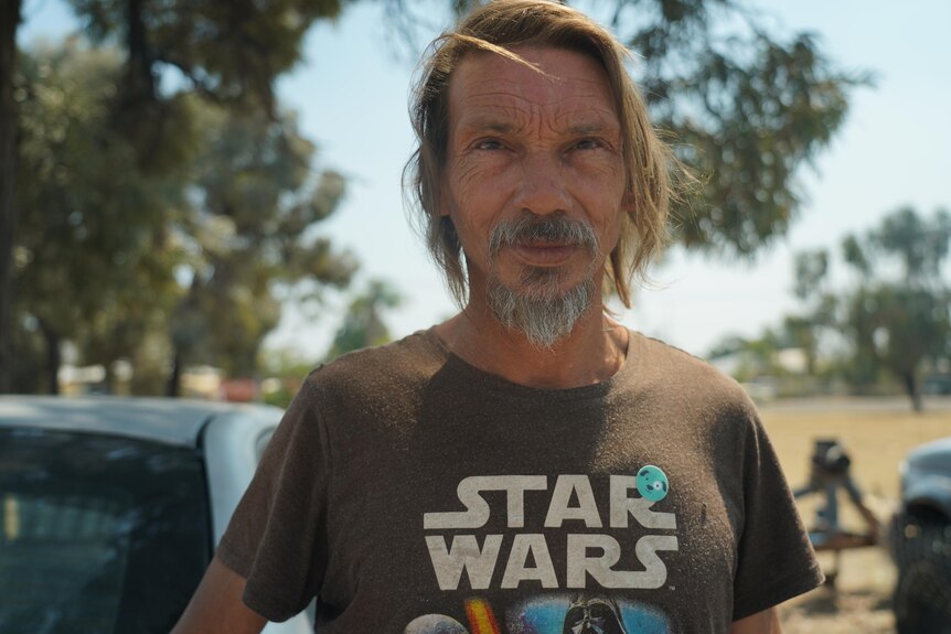 A man with a beard wearing a Star Wars t-shirt.