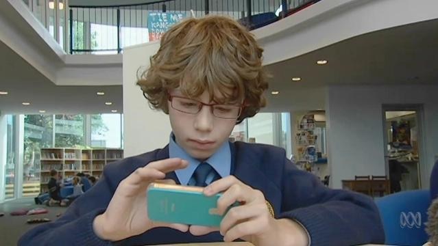 Boy holds mobile smartphone