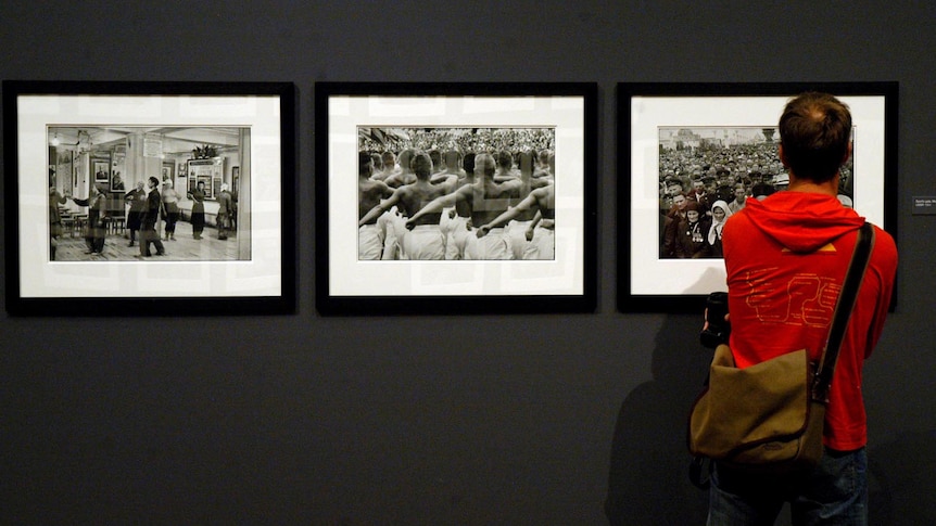 A man studies some of the photos at the Henri Cartier-Bresson exhibition