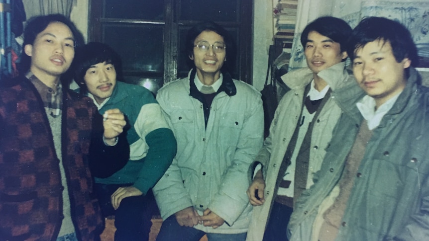 A group of young Chinese men in an old photo from the 1980s. 