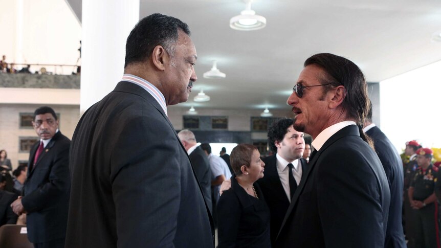 Reverend Jesse Jackson and actor Sean Penn attend Chavez funeral
