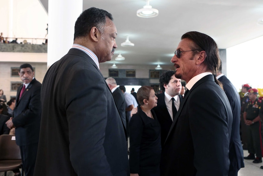 Reverend Jesse Jackson and actor Sean Penn attend Chavez funeral