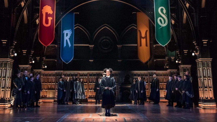 Hogwarts students are sorted into houses during a Harry Potter and the Cursed Child performance in London's Palace Theatre.