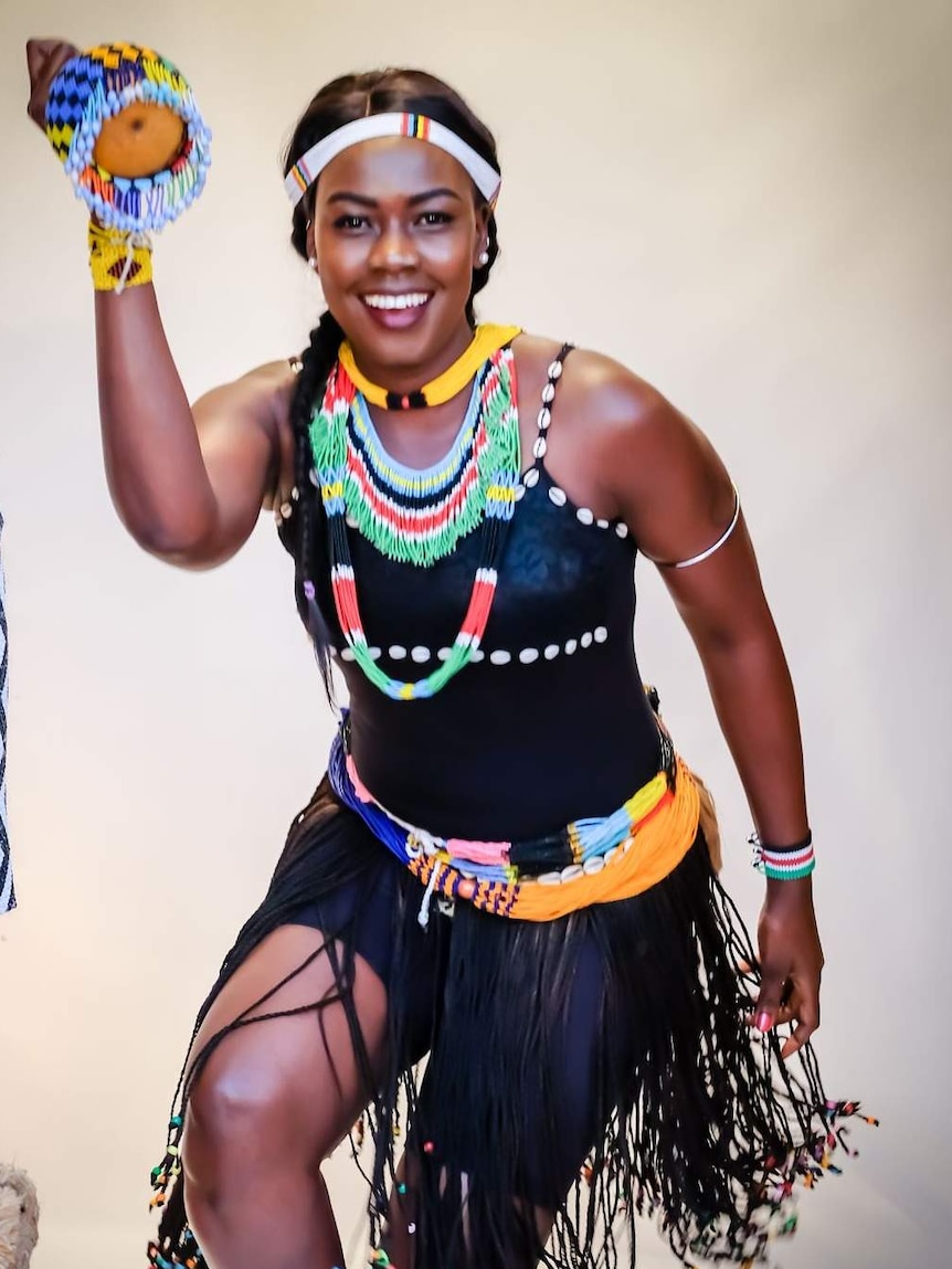 South Sudanese singer wearing traditional dress.