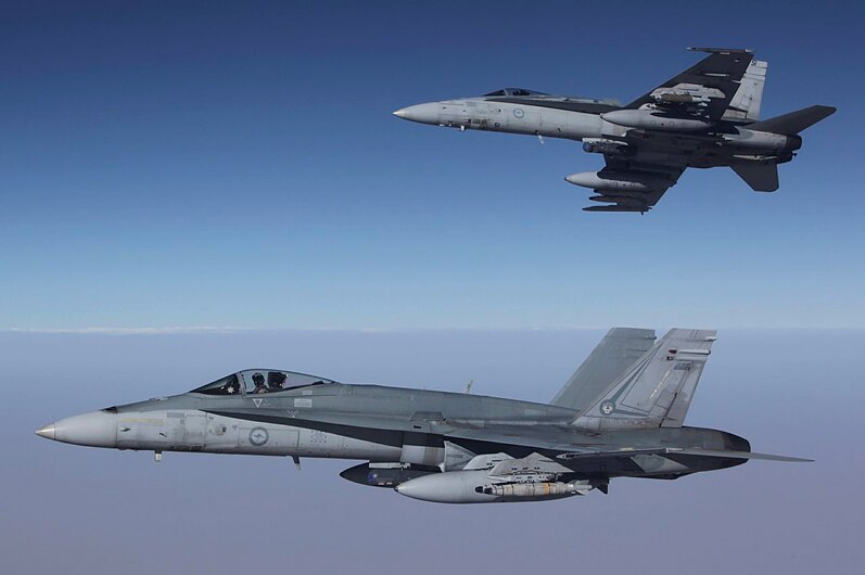 FA-18A Hornets from Australia's Air Task Group fly in formation with a Royal Australian Air Force KC-30A Multi Role Tanker Transport aircraft during the first mission of Operation OKRA to be flown over Syria