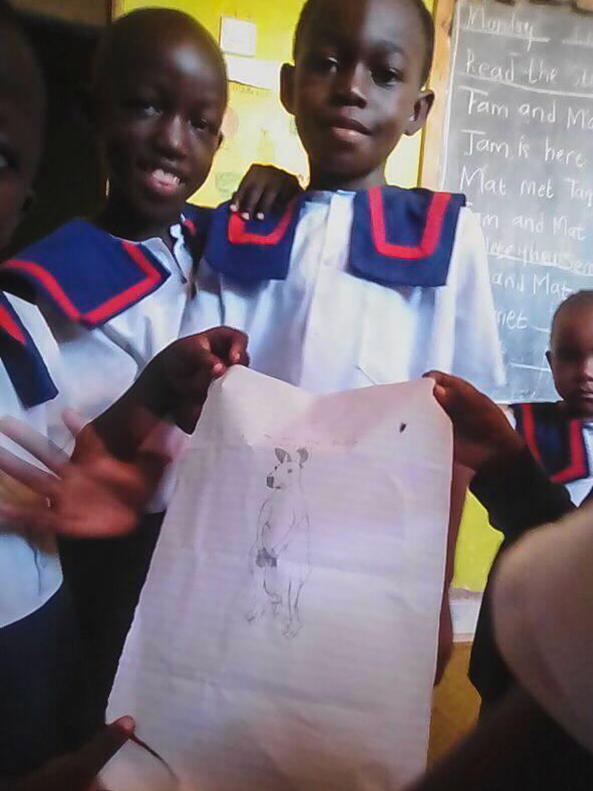 Children at Maryland Nursery School in Likoni in Kenya displaying their artwork.