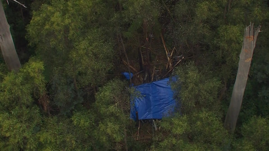 A tarpaulin over a helicopter.