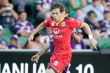 On the attack ... Adelaide United's Craig Goodwin looks to pass the ball