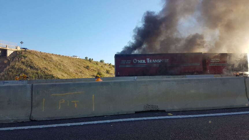 A truck catches fire after a collision with another truck at Bacchus Marsh.