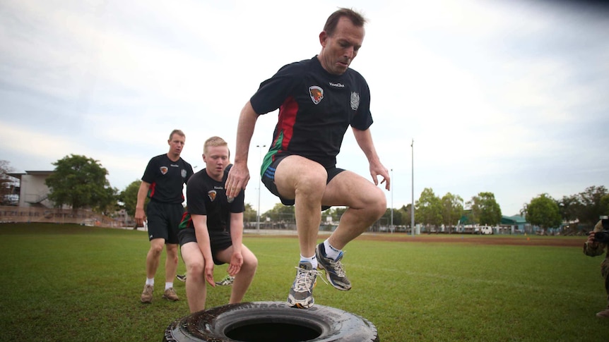 Tony Abbott goes through an exercise session with troops in Darwin