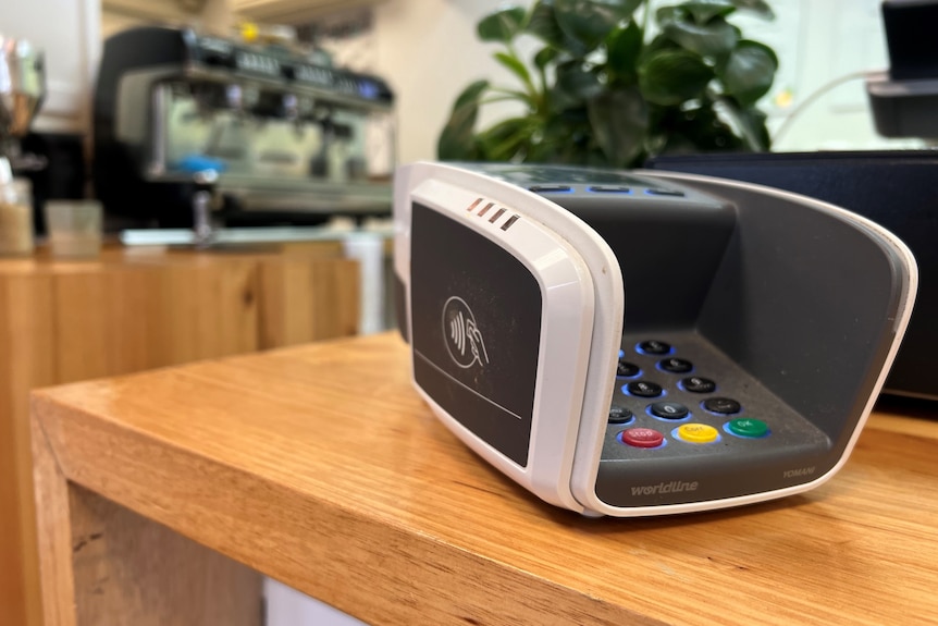 An EFTPOS machine sits on a table.