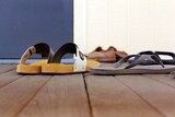 Sandals and thongs on timber decking outside the prayer room.