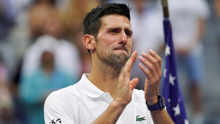 Novak Djokovic applauds with tears in his eyes