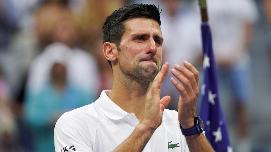 Novak Djokovic claps with tears in his eyes