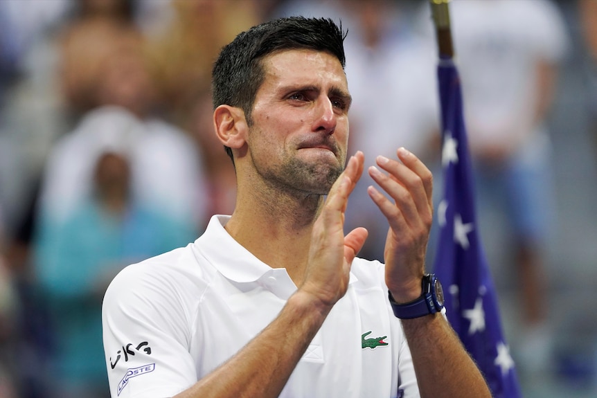 Novak Djokovic claps with tears in his eyes