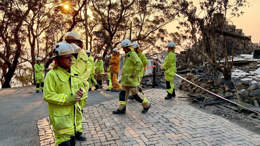 Firefighters at the destroyed Binna Burra Lodge in the Lamington National Park.