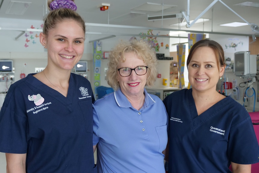 Charlotte, Maxine and another nurse standing together, arms around each other in the special care unit.