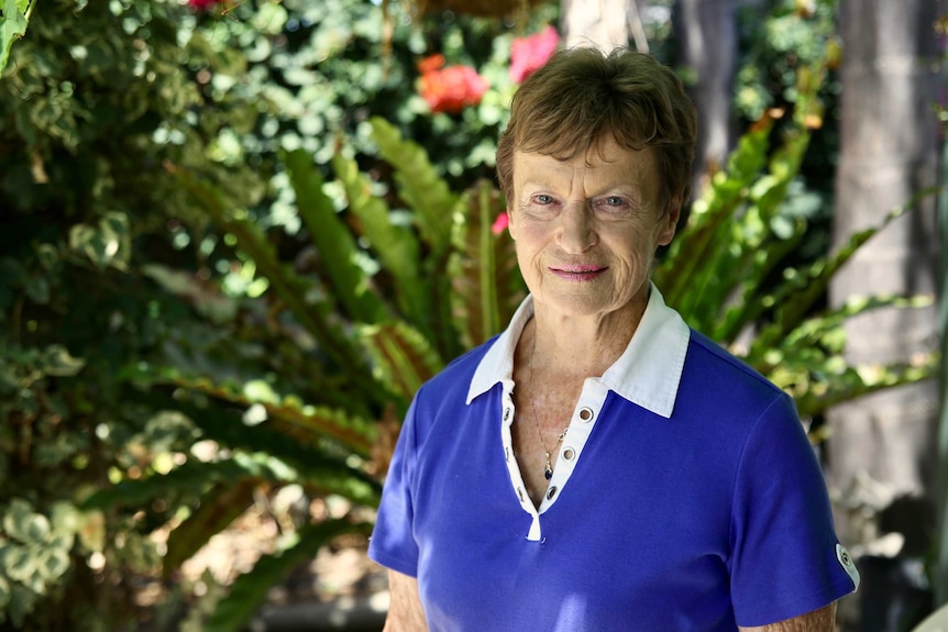 Fran Garland standing in front of a garden bed