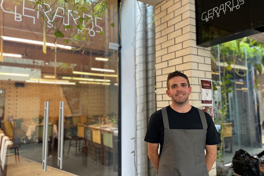 Photo of a man outside a restaurant.