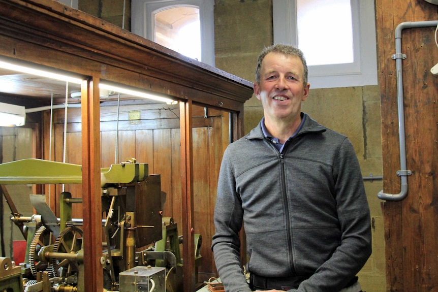 Peter Reading next to the movement of the GPO clock