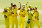 Ellyse Perry of Australia celebrates with teammates after bowling out Emma Lamb of England in the Ashes series