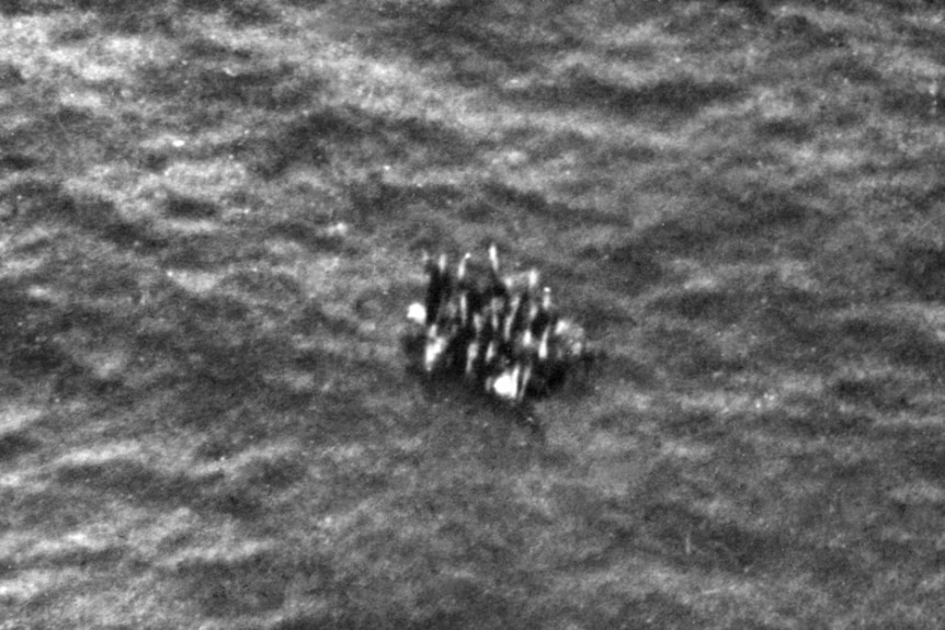 Survivors of HMAS Armidale in a life raft, spotted from the air.