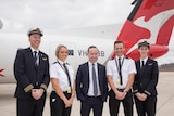 CEO Alan Joyce and students standing in front of a plane at Wellcamp Airport.