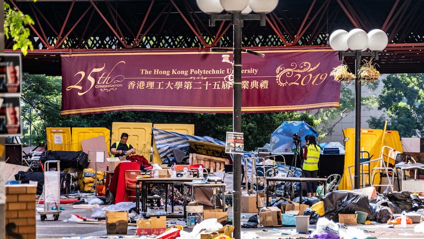 Rubbish is piled in front of a Hong Kong Polytechnic University banner