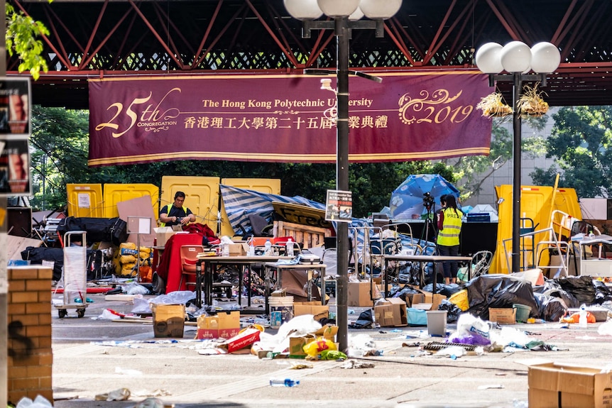 Rubbish is piled in front of a Hong Kong Polytechnic University banner