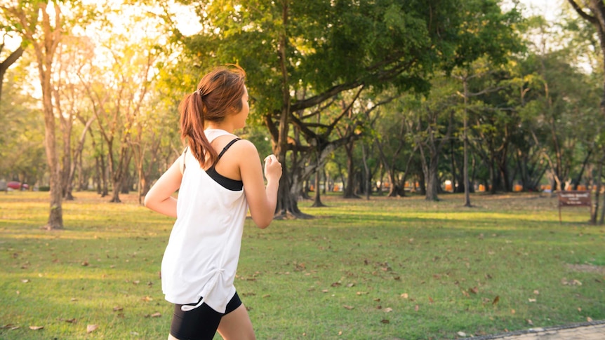 A woman runs in a park